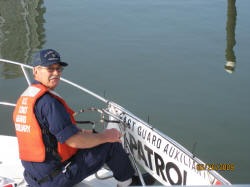 Steve Krok  hangs auxiliary banner on facility "Obsession" in preparation for participation in 70th anniversary NY Harbor parade